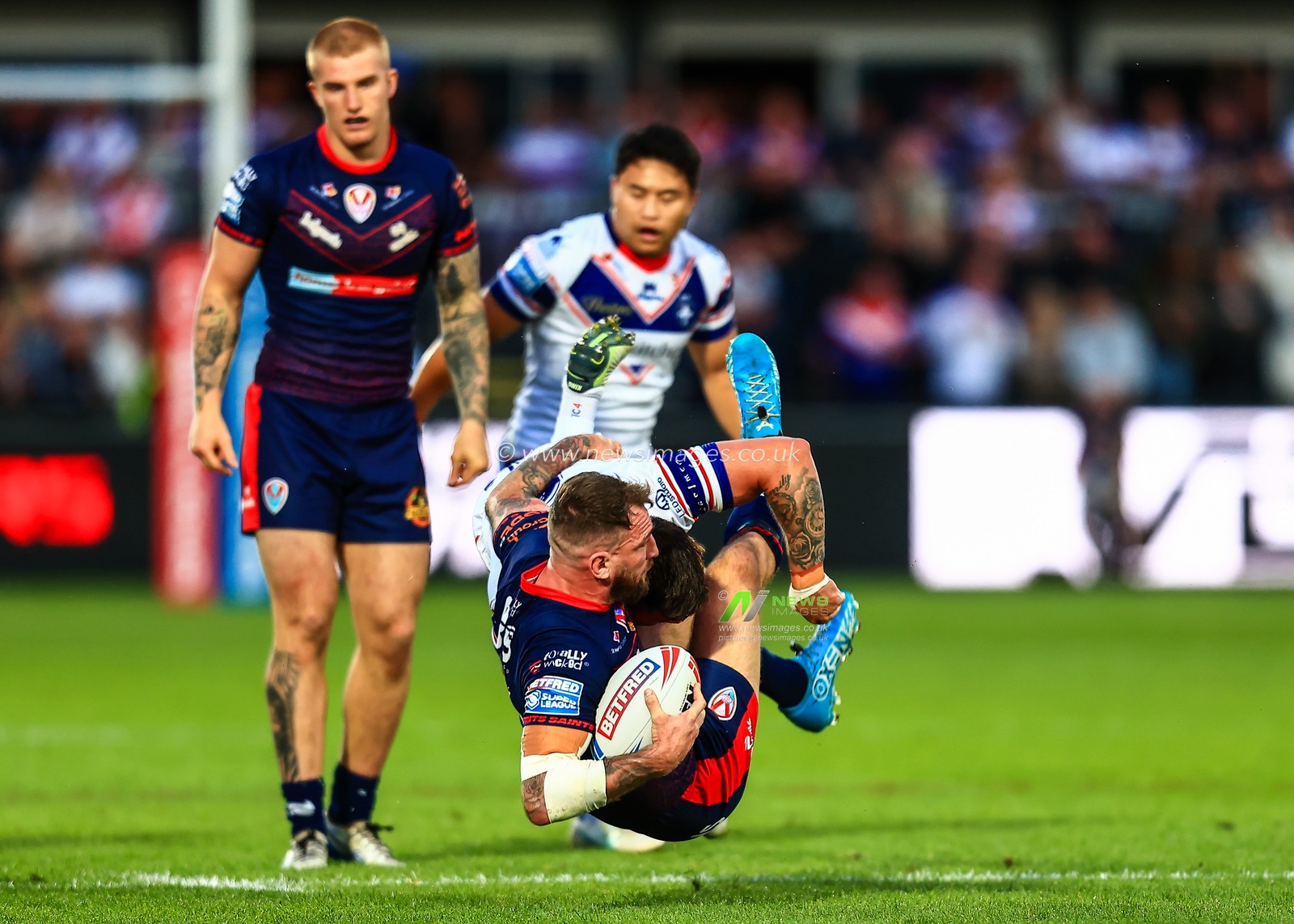 Daryl Clark of St. Helens is tackled by Liam Hood of Wakefield Trinity during the Betfred Super League round 21 match Wakefield Trinity vs St Helens at DIY Kitchens Stadium, Wakefield, United Kingdom, 8th August 2025

(Photo by Richard Bierton/News Images)
