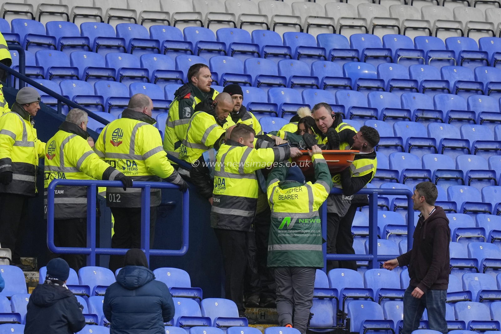 Stewards and Paramedics lift a stretcher down from the stand during a medical emergency during the Sky Bet League 1 match Bolton Wanderers vs Cheltenham Town at Toughsheet Community Stadium, Bolton, United Kingdom, 13th January 2024

(Photo by Steve Flynn/News Images)