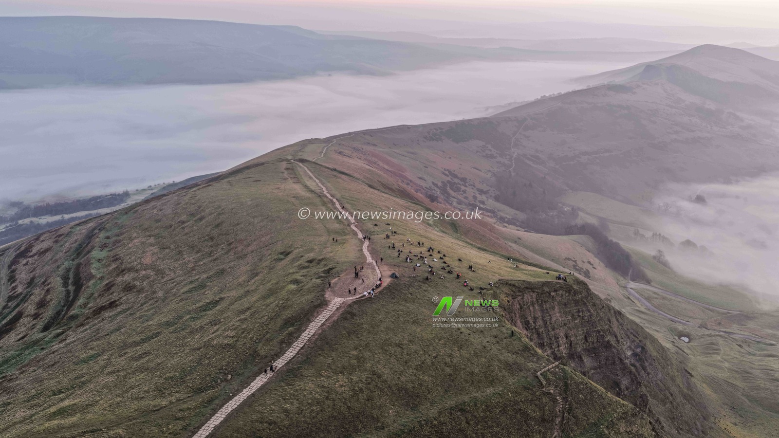 Sunrise hikers walk to the summit of Mam Tor as they watch the sunrise and admire the cloud inversion in the Hope Valley at Mam Tor in the Peak District at Mam Tor, Castleton, United Kingdom on 21 March 2026

(Photo by Mark Cosgrove/News Images)