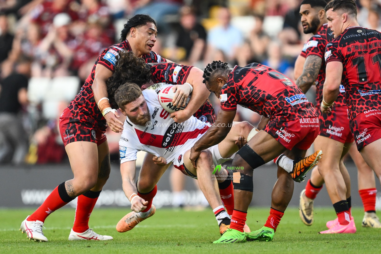 Ethan Ryan of Salford Red Devils is tackled by Edwin Ipape of Leigh Leopards during the Betfred Super League Round 11 match Leigh Leopards vs Salford Red Devils at Leigh Sports Village, Leigh, United Kingdom, 10th May 2024

(Photo by Craig Thomas/News Images)