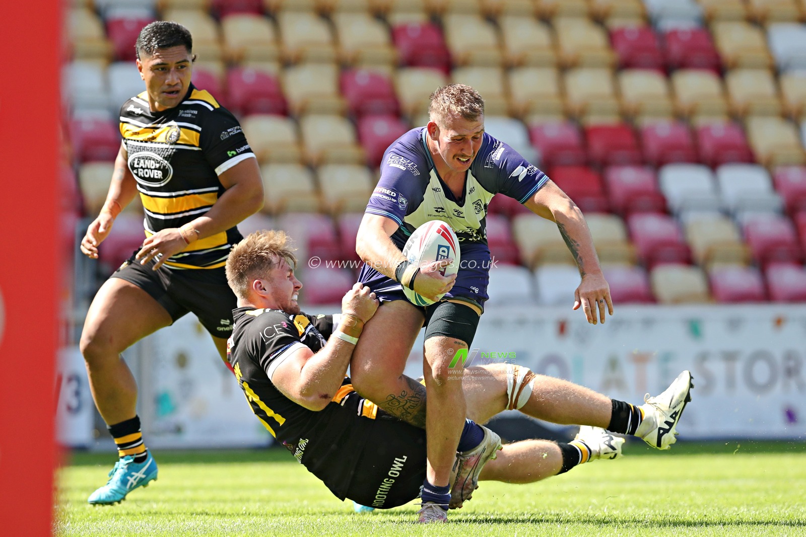 Josh Hardcastle of Featherstone Rovers is tackled by Kieran Hudson of York Knights RLFC during the Betfred Championship match York City Knights vs Featherstone Rovers at LNER Community Stadium, York, United Kingdom, 29th June 2025(Photo by Sam Eaden/News Images)