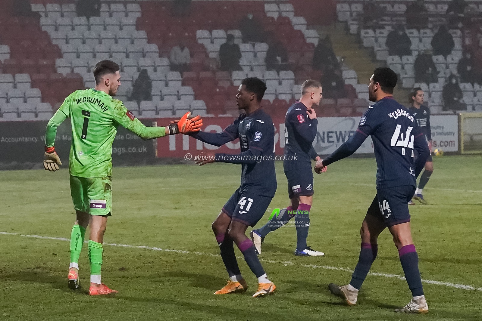 Freddie Woodman #1 of Swansea City is congratulated for save the penalty kick