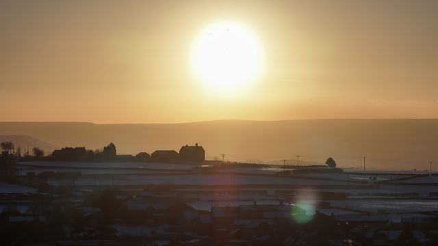 The sun sets over Emley Moor transmitting tower and the snow covered village of Emley as Sub-zero temperatures continue to hamper the north of the United Kingdom; Emley, Huddersfield, United Kingdom, 10th January 2025

(Photo by Mark Cosgrove/News Images)