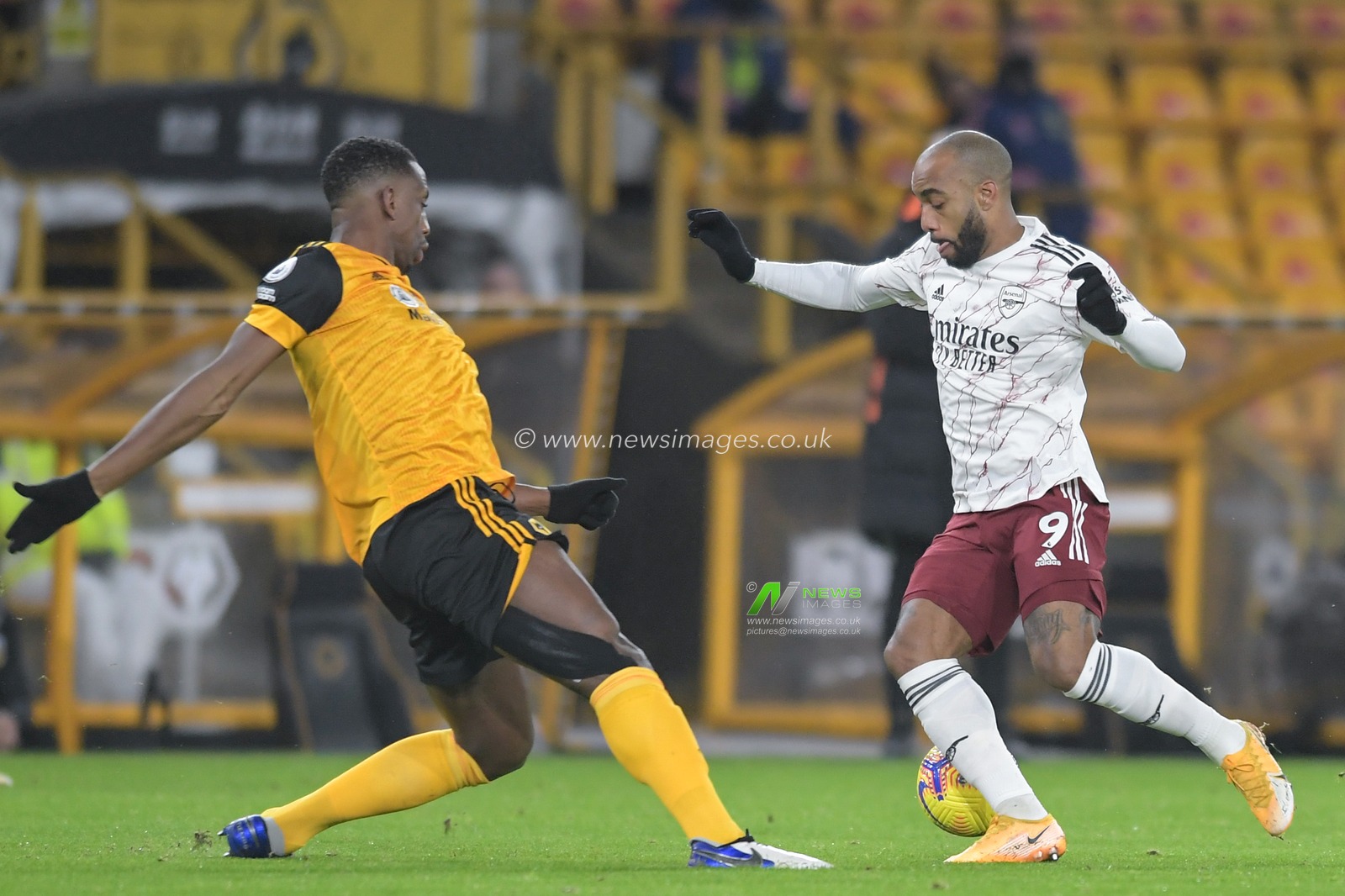 Alexandre Lacazette #9 of Arsenal looks for a way past Willy Boly #15 of Wolverhampton Wanderers