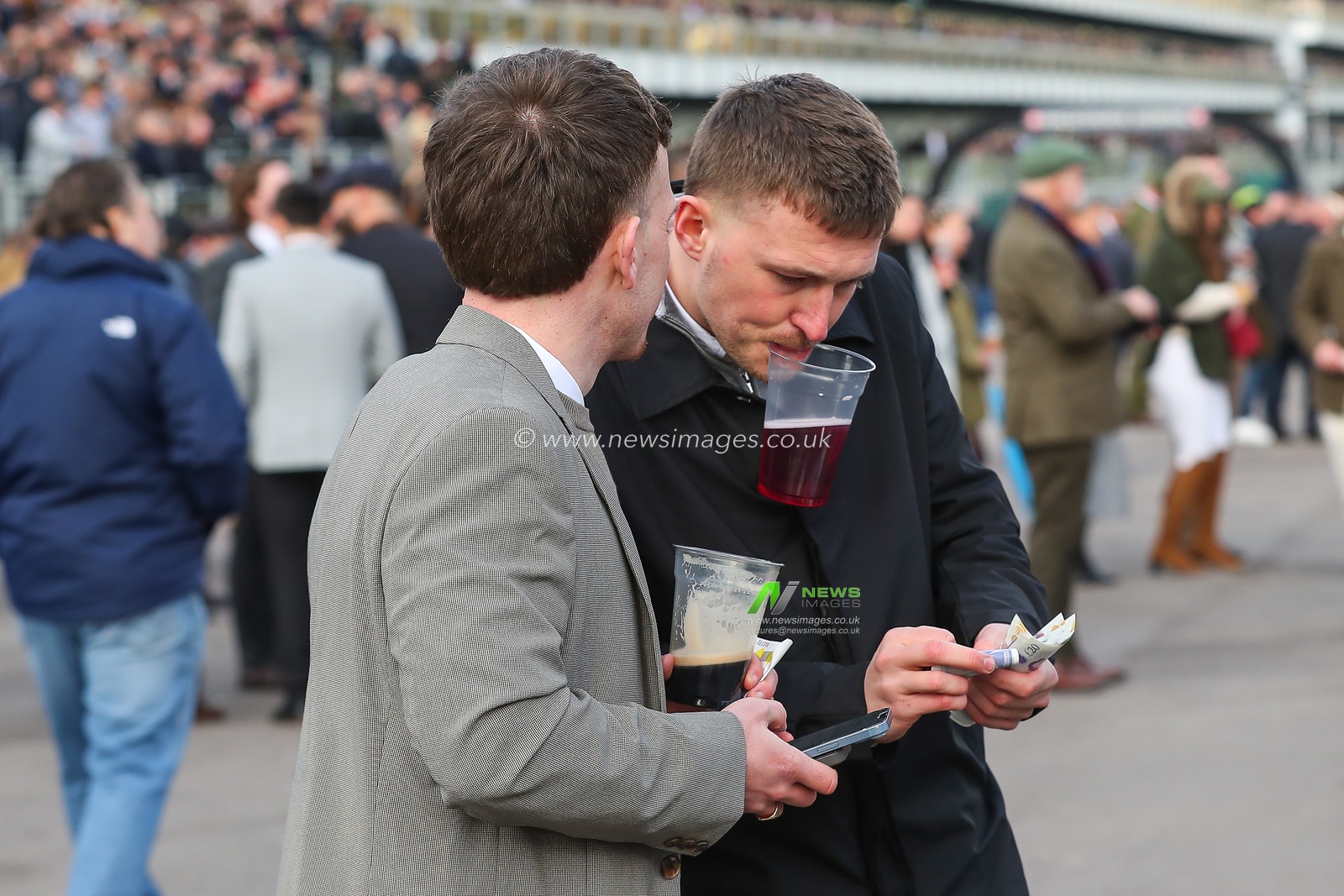 Racegoers count their winnings during the Cheltenham Festival 2025 Style Wednesday at Cheltenham Racecourse, Cheltenham, United Kingdom, 12th March 2025

(Photo by Gareth Evans/News Images)