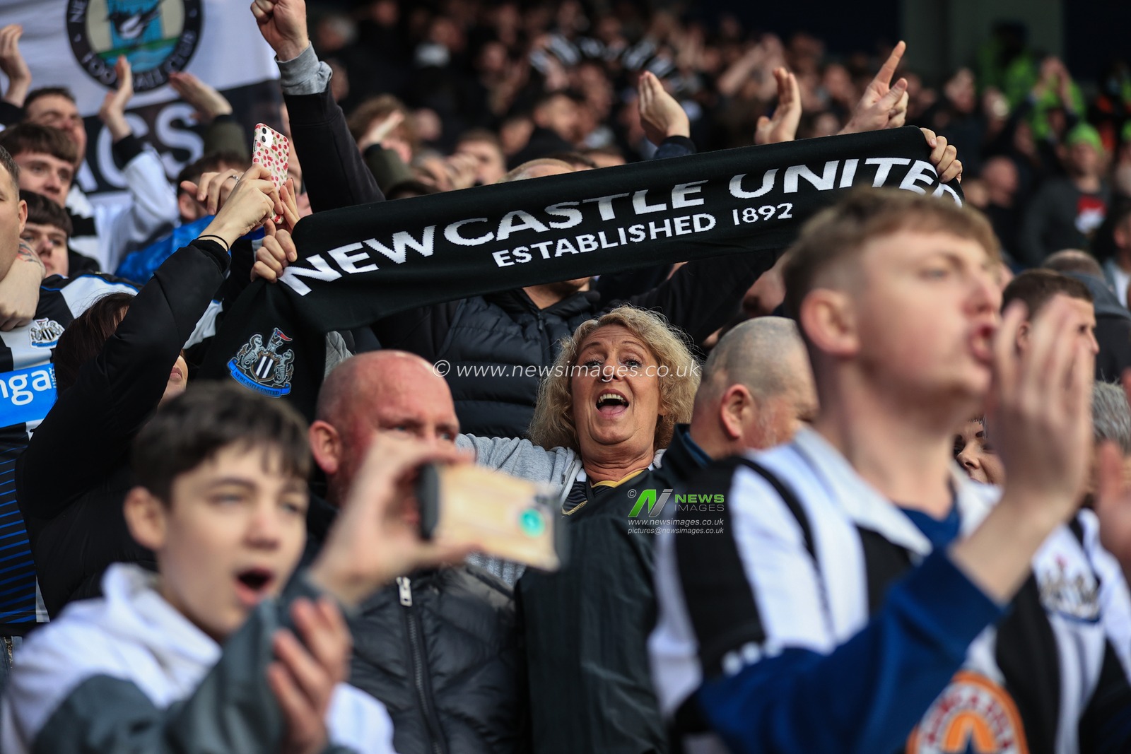 Newcastle fans sing away as the game get underway