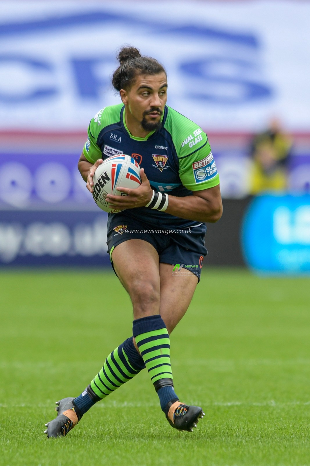 Ashton Golding (1) of Huddersfield Giants runs with the ball