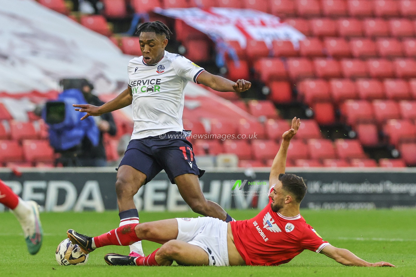 Dan Nâ€™Lundulu #11 of Bolton Wanderers is tackled by Adam Phillips #30 of Barnsley during the Sky Bet League 1 Play-off match Barnsley vs Bolton Wanderers at Oakwell, Barnsley, United Kingdom, 19th May 2023

(Photo by Mark Cosgrove/News Images)