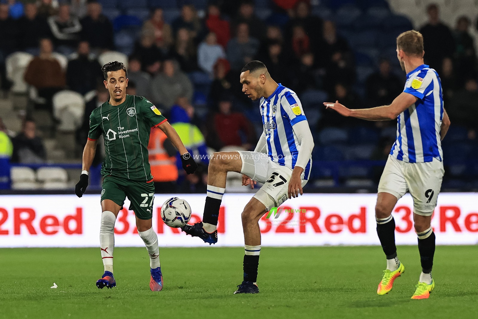 Jon Russell #37 of Huddersfield Town controls the ball