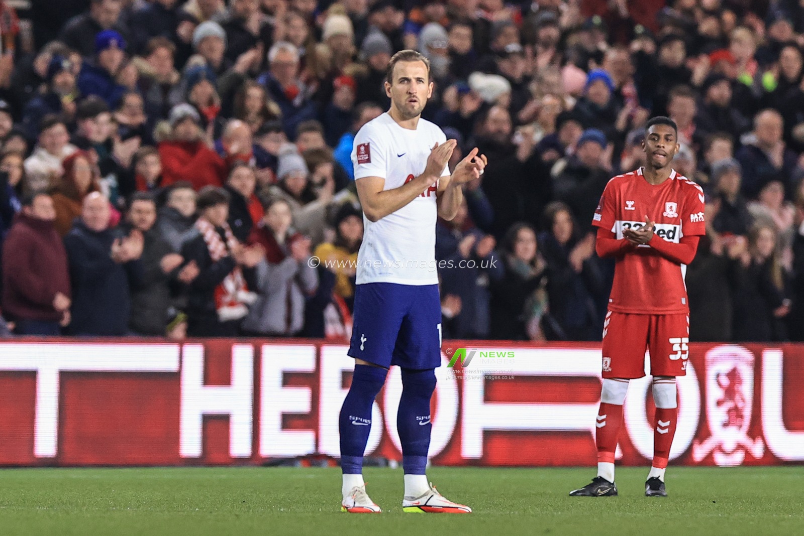 Harry Kane #10 of Tottenham Hotspur and the whole stadium hold a minutes applause to show unity with the Ukraine