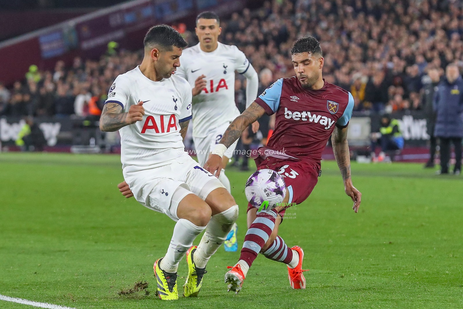 Emerson Palmieri of West Ham United challenges Cristian Romero of Tottenham Hotspur for the ball during the Premier League match West Ham United vs Tottenham Hotspur at London Stadium, London, United Kingdom, 2nd April 2024

(Photo by Gareth Evans/News Images)