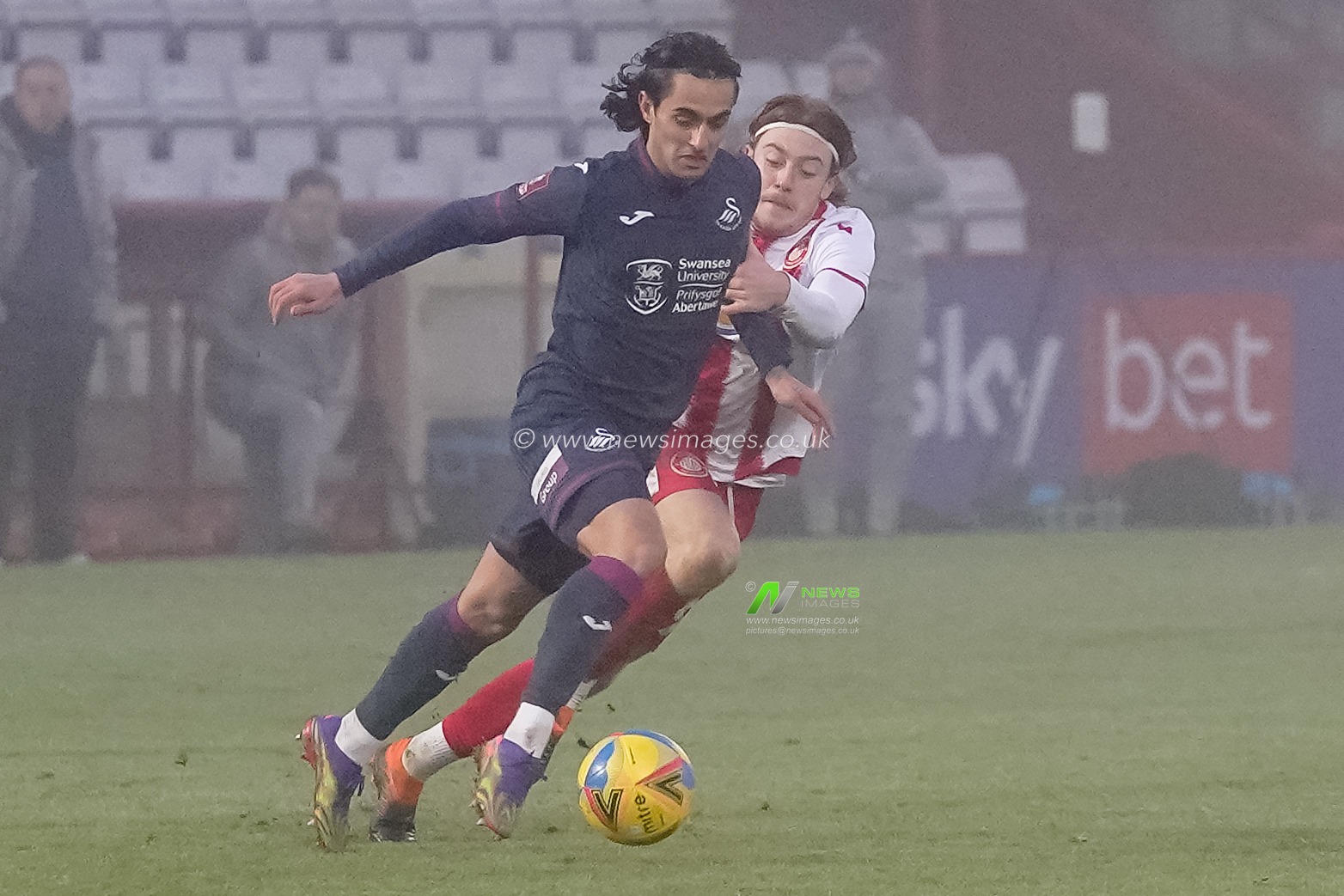 Yan Dhanda #21 of Swansea City battles with Arthur Read #19 of Stevenage