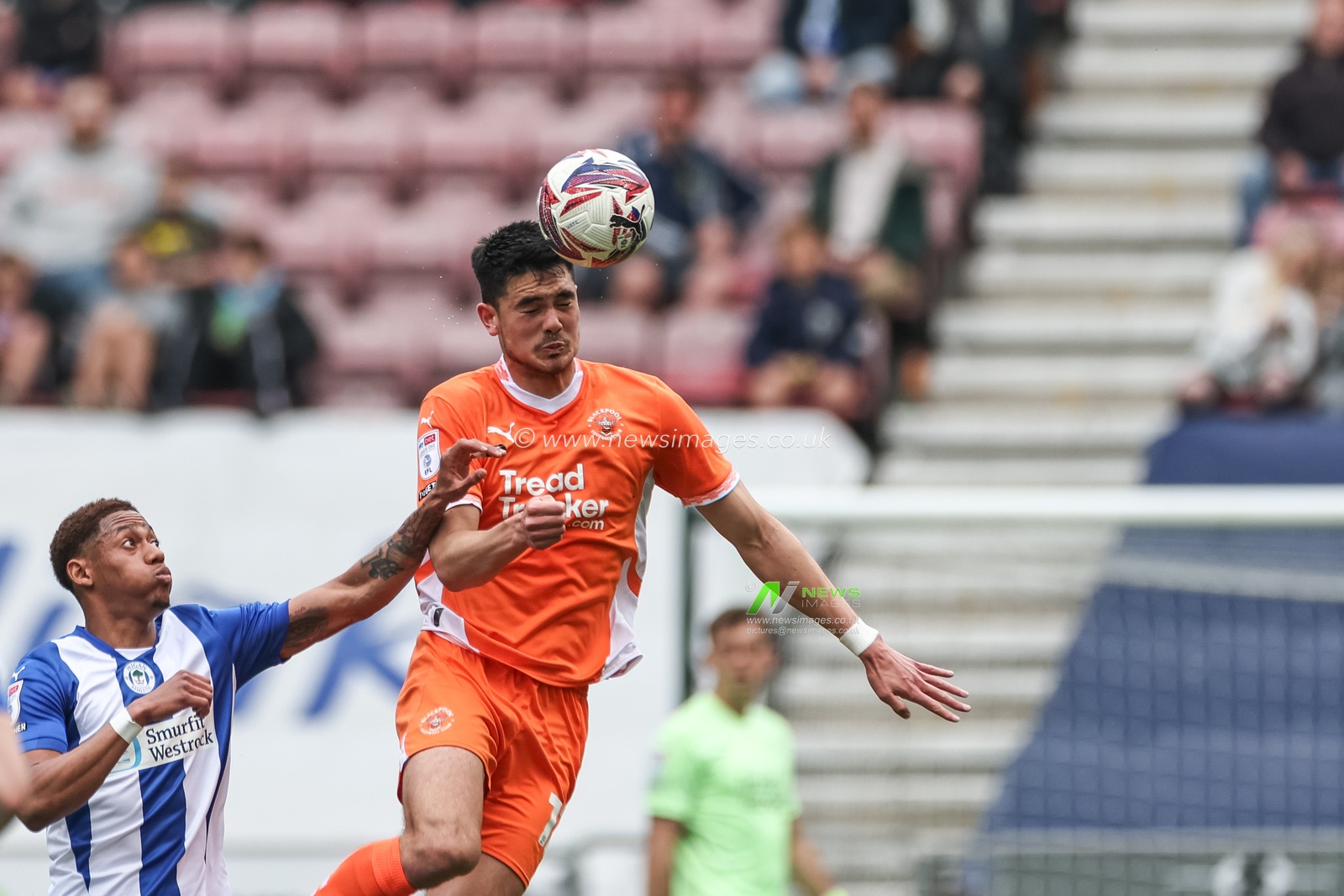 Elkan Baggott of Blackpool jumps up to win the high ball during the Sky Bet League 1 match Wigan Athletic vs Blackpool at The Brick Community Stadium, Wigan, United Kingdom, 26th April 2025

(Photo by Mark Cosgrove/News Images)