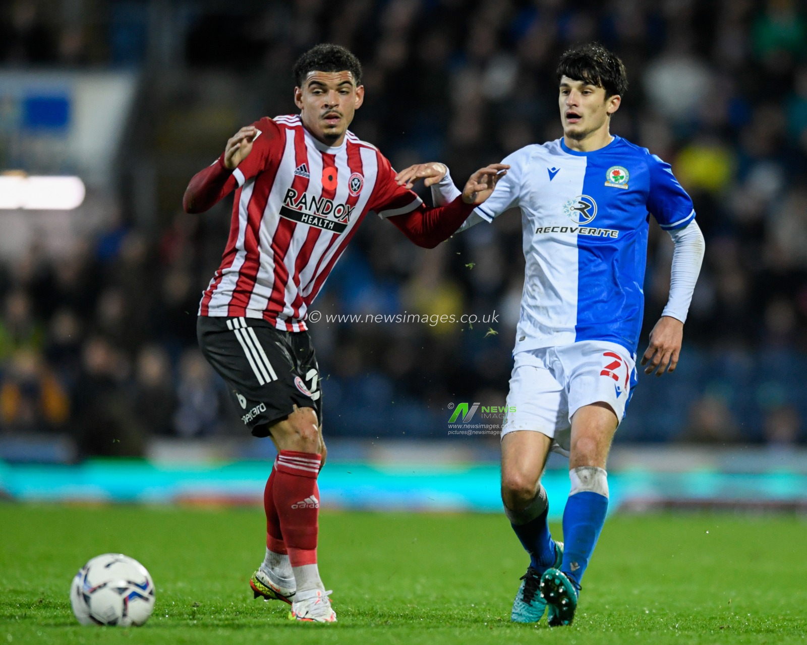Morgan Gibbs-White #27 of Sheffield United and John Buckley #21 of Blackburn Rovers compete for the ball