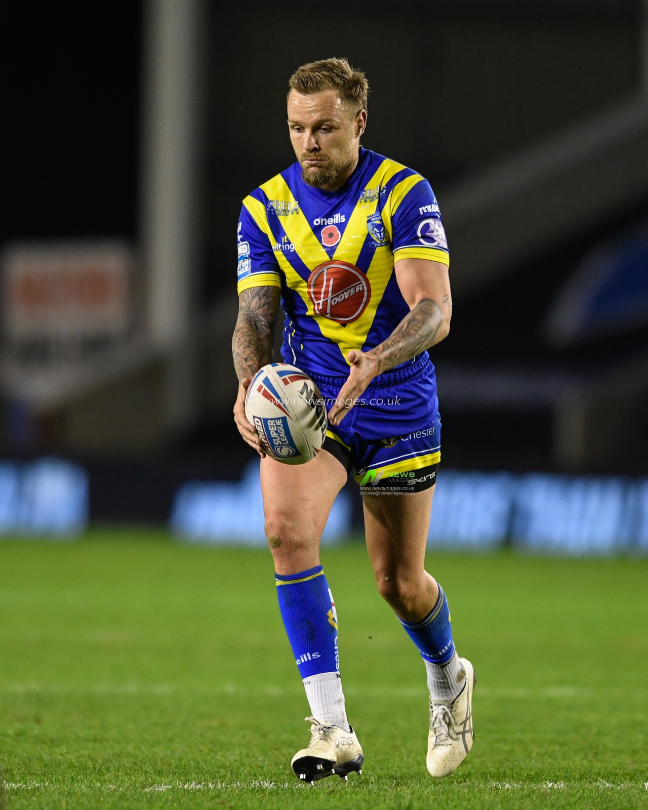 Blake Austin #6 of Warrington Wolves looks to kick the ball
