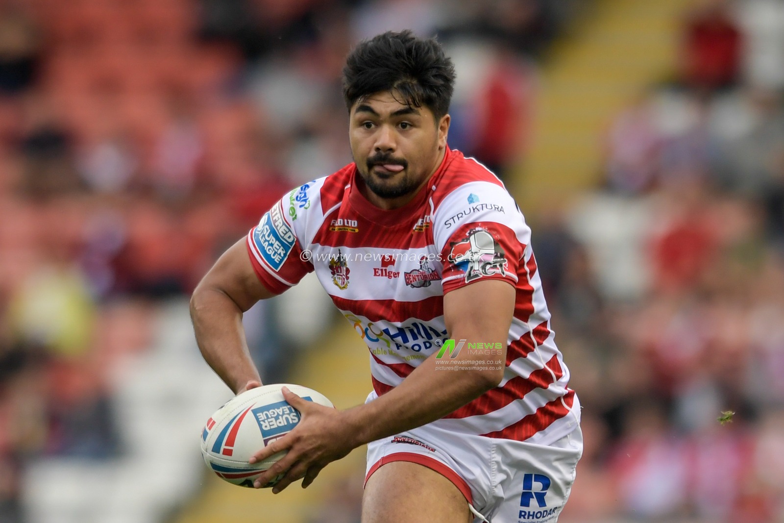 James Bell (13) of Leigh Centurions runs with the ball