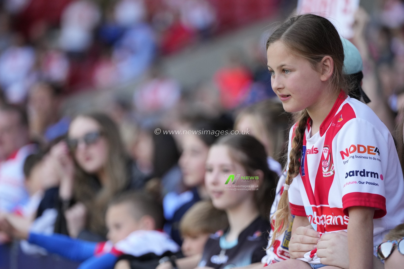 A young St Helens fan watches the game during the Betfred Super League Round 12 match St Helens vs Salford Red Devils at Totally Wicked Stadium, St Helens, United Kingdom, 13th May 2023

(Photo by Steve Flynn/News Images)
