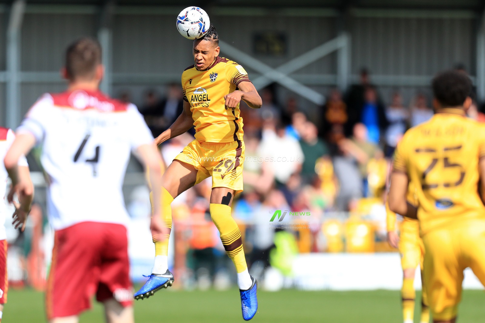 Alistair Smith #29 of Sutton United heading the ball.
