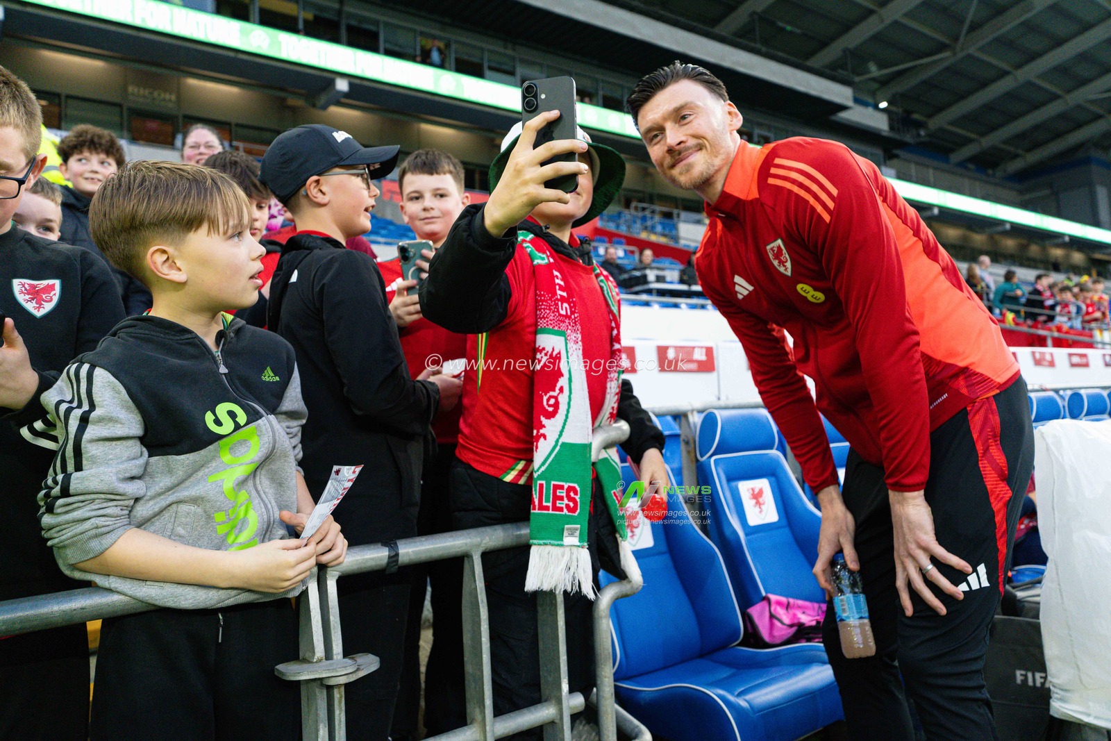 Kieffer Moore of Wales poses for a photograph with a young Welsh fan, ahead of the FIFA World Cup Qualifiers Group J match Wales vs Kazakhstan at Cardiff City Stadium, Cardiff, United Kingdom, 22nd March 2025

(Photo by Andrew Lewis/News Images)