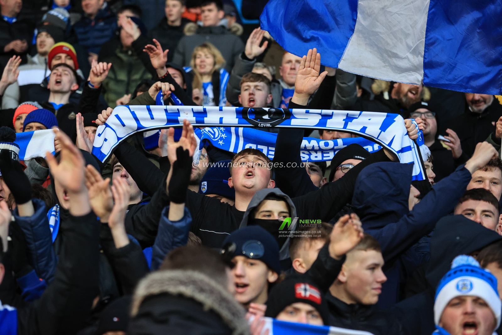 Huddersfield fans sing away in the cowshed as the game gets underway