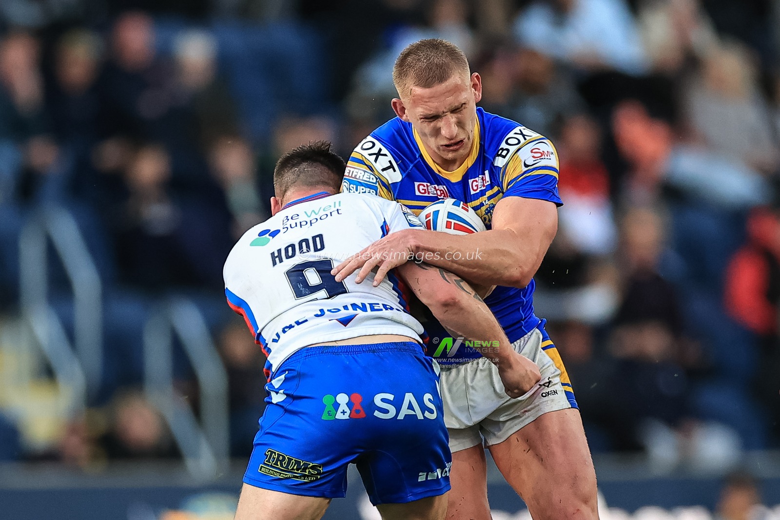 Mikolaj OlÄ™dzki of Leeds Rhinos barges into Liam Hood #9 of Wakefield Trinity