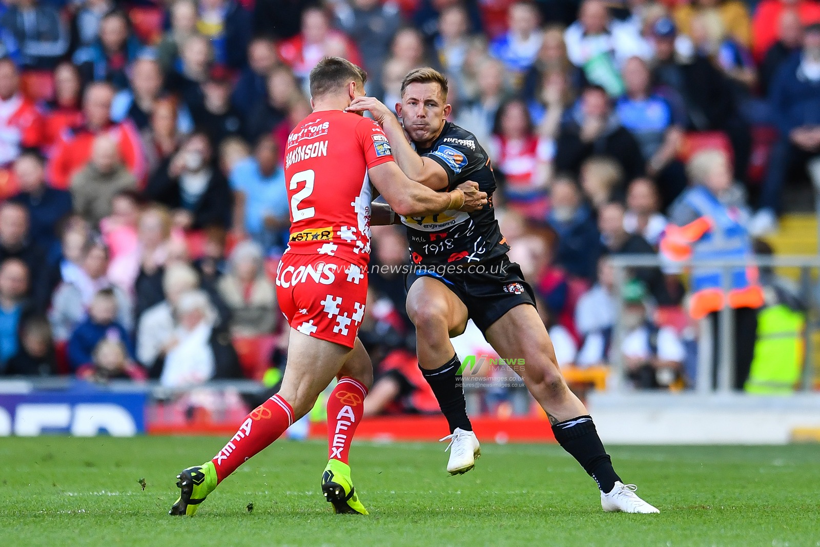 26th May 2019 , Anfield Stadium, Liverpool, England; Dacia Magic Weekend, Betfred Super League Round 16, St Helens vs Castleford Tigers ; Greg Eden (5) of Castleford Tigers is tackled by Tommy Makinson (2) of St Helens 

Credit: Craig Thomas/News Images