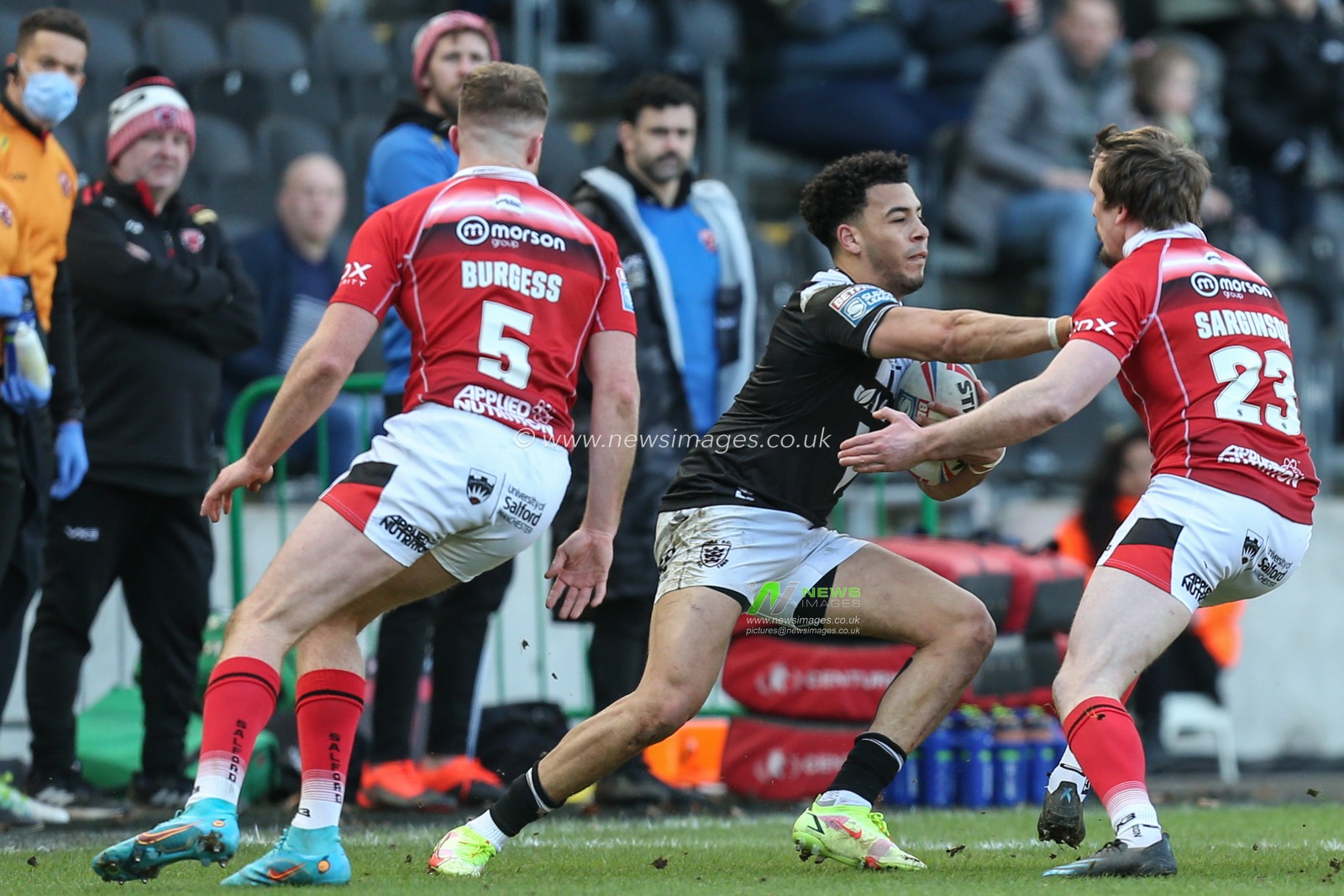 Darnell McIntosh (5) of Hull FC runs at Dan Sarginson (23) of Salford Red Devils