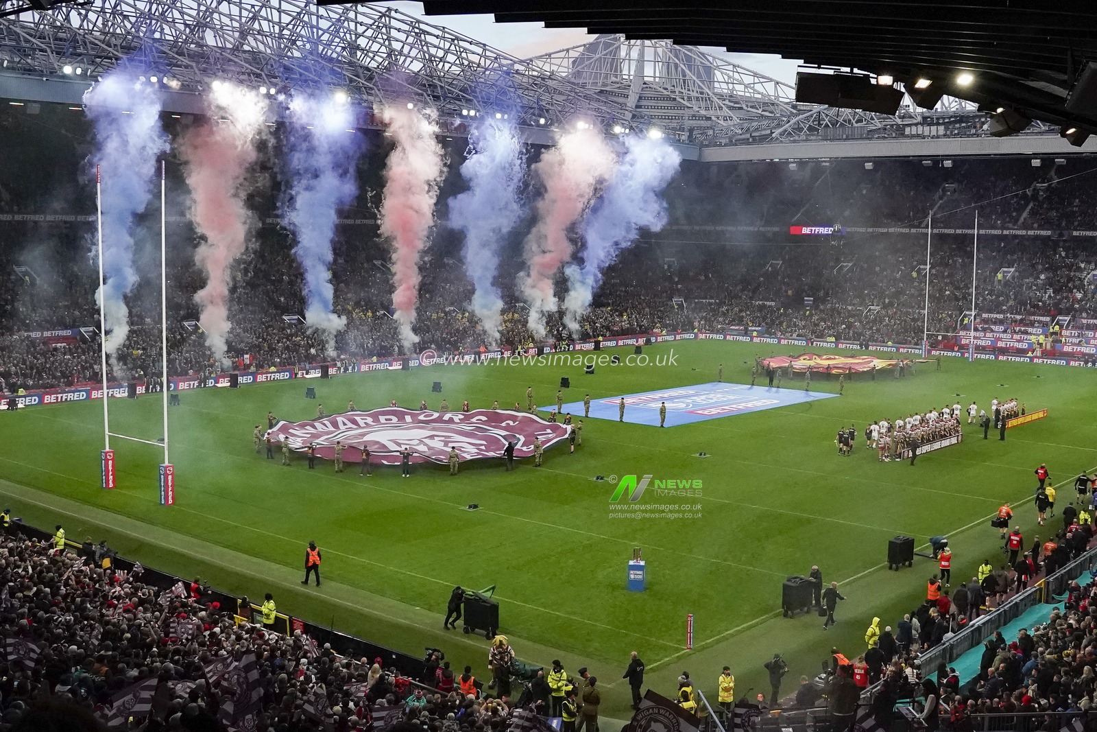 Players from both sides walk out to pyrotechnics before the Betfred Super League Grand Final match Wigan Warriors vs Catalans Dragons at Old Trafford, Manchester, United Kingdom, 14th October 2023

(Photo by Steve Flynn/News Images)