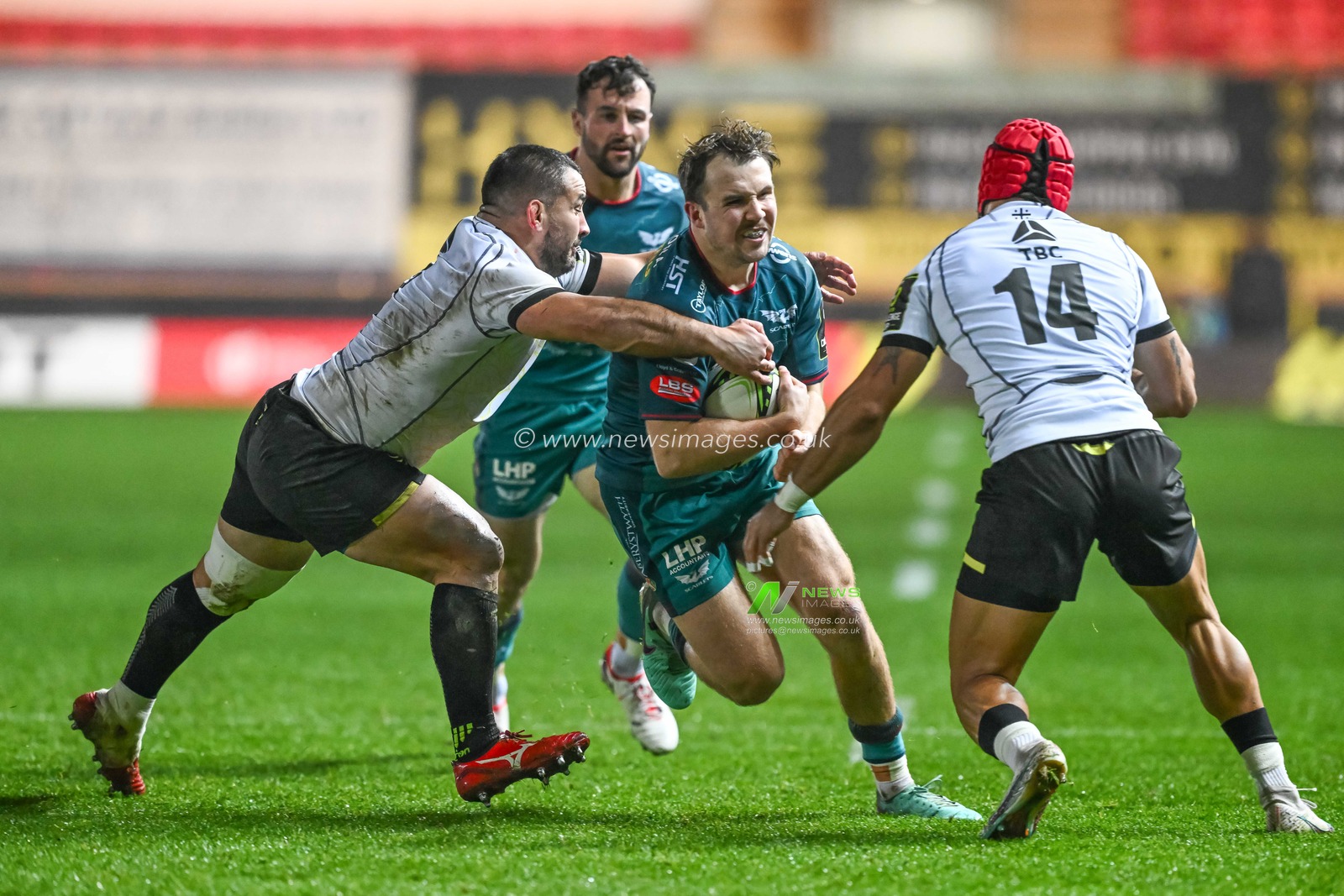 Ioan Lloyd of Scarlets is tackled by Beka Mamrikashvili of Black Lion during the European Rugby Challenge Cup match Llanelli Scarlets vs Black Lion at Parc y Scarlets, Llanelli, United Kingdom, 15th December 2023

(Photo by Craig Thomas/News Images)
