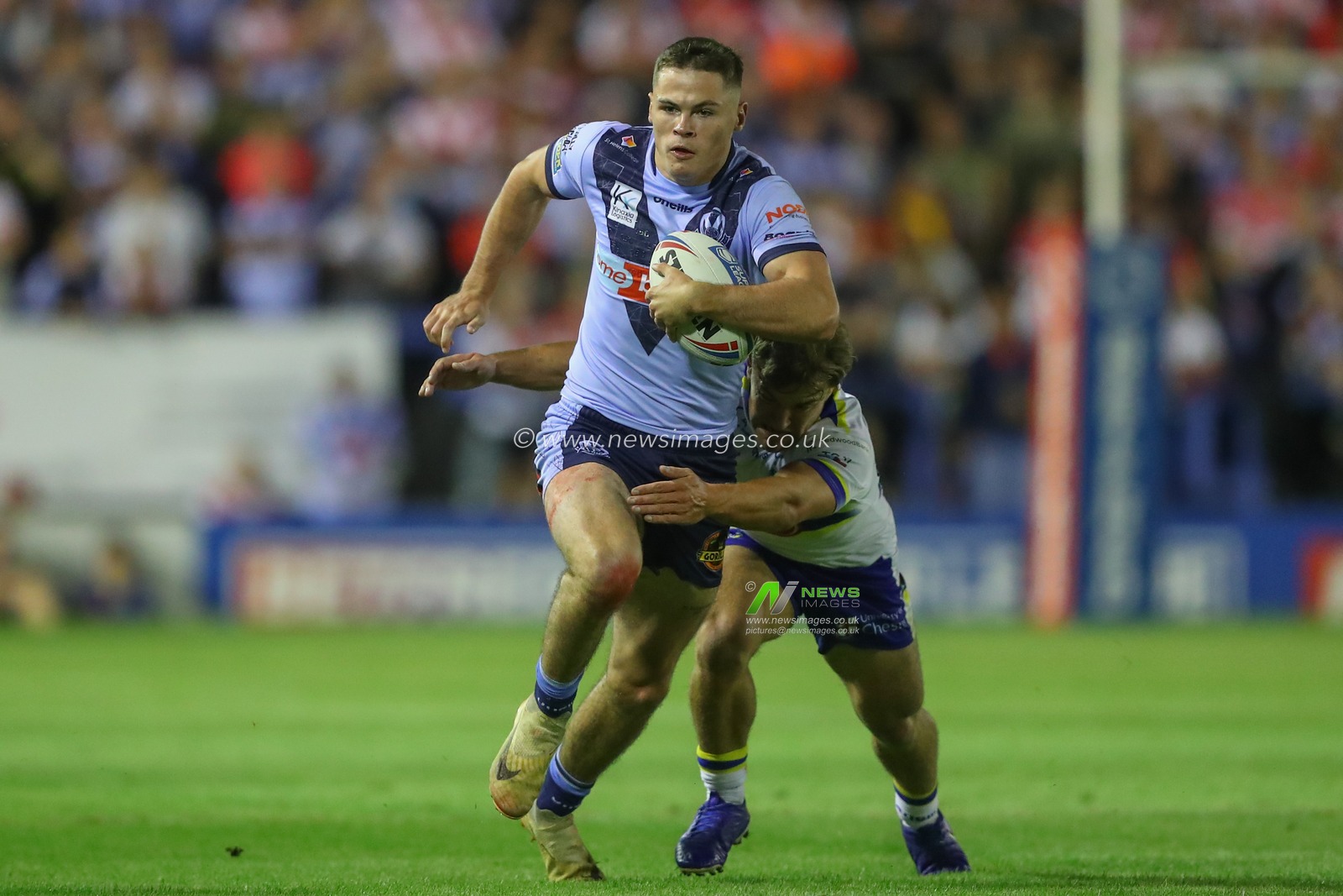 Jack Welsby #1 of St Helens is tackled by Leon Hayes #25 of Warrington Wolves during the Betfred Super League Round 26 match Warrington Wolves vs St Helens at Halliwell Jones Stadium, Warrington, United Kingdom, 15th September 2023

(Photo by Gareth Evans/News Images)