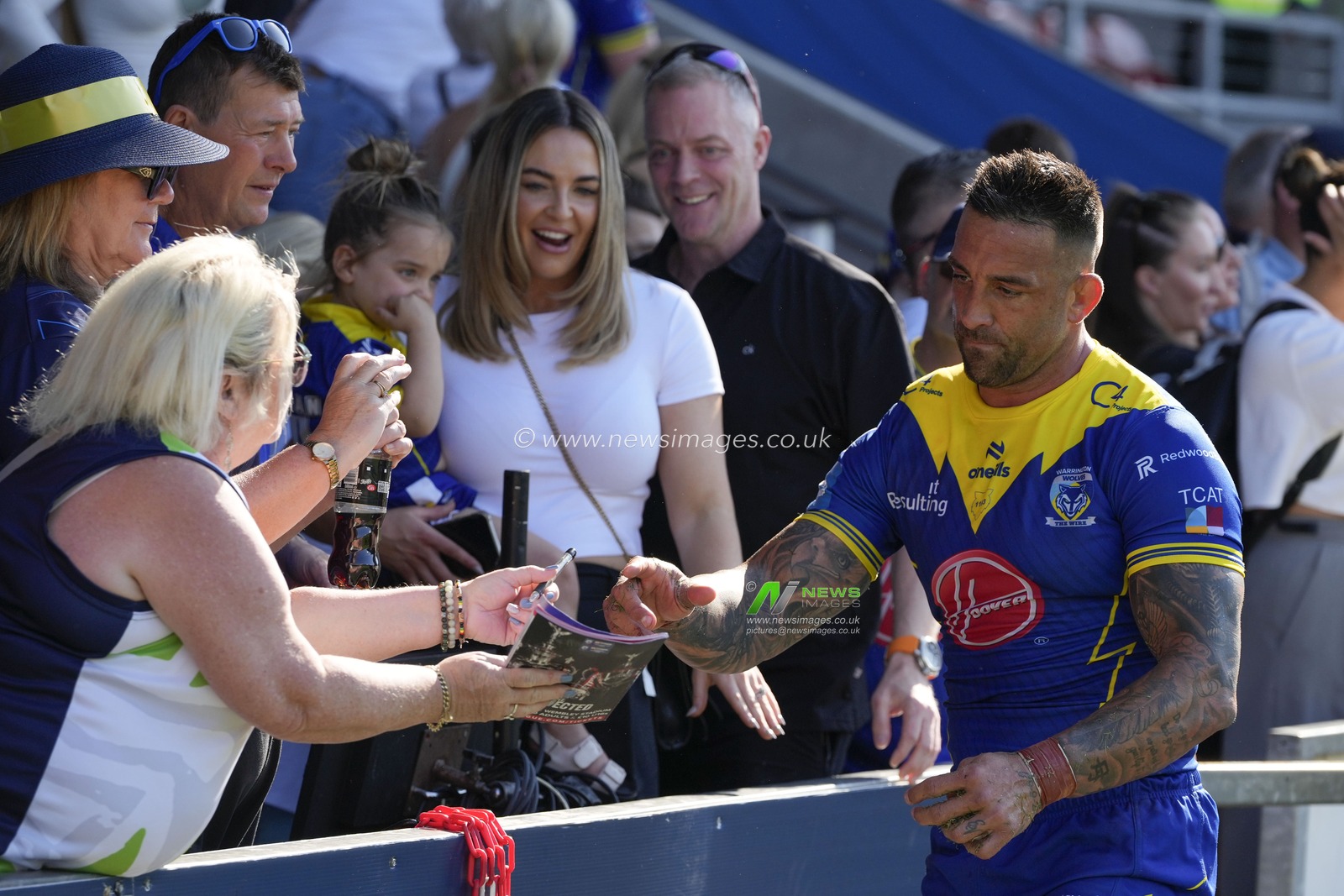 Paul Vaughan of Warrington Wolves signs an autograph for a fan after the Betfred Challenge Cup Semi-Final match Huddersfield Giants vs Warrington Wolves at Totally Wicked Stadium, St Helens, United Kingdom, 19th May 2024

(Photo by Steve Flynn/News Images)