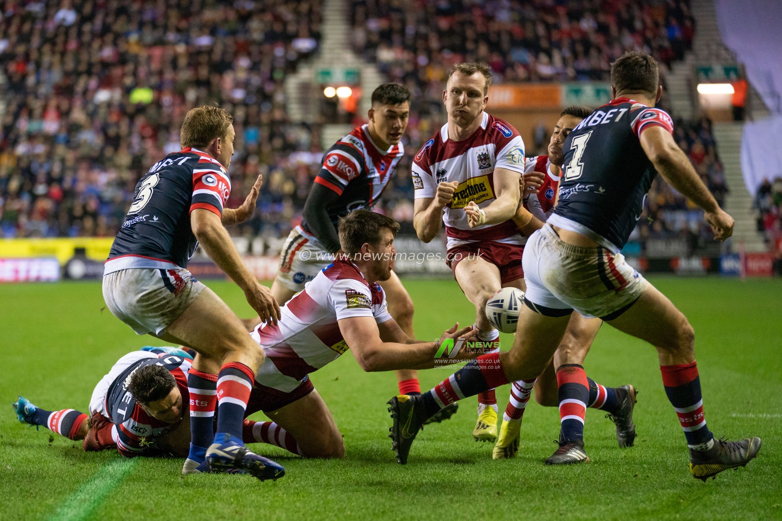 Wigan Warriors's Joe Greenwood is tackled by  Sydney Roosters Cooper Cronk


17th February  2019 , DW Stadium, Wigan, England;  Betfred World Club Challenge, Wigan Warriors vs Sydney Roosters ; 

Credit: Terry Donnelly/News Images