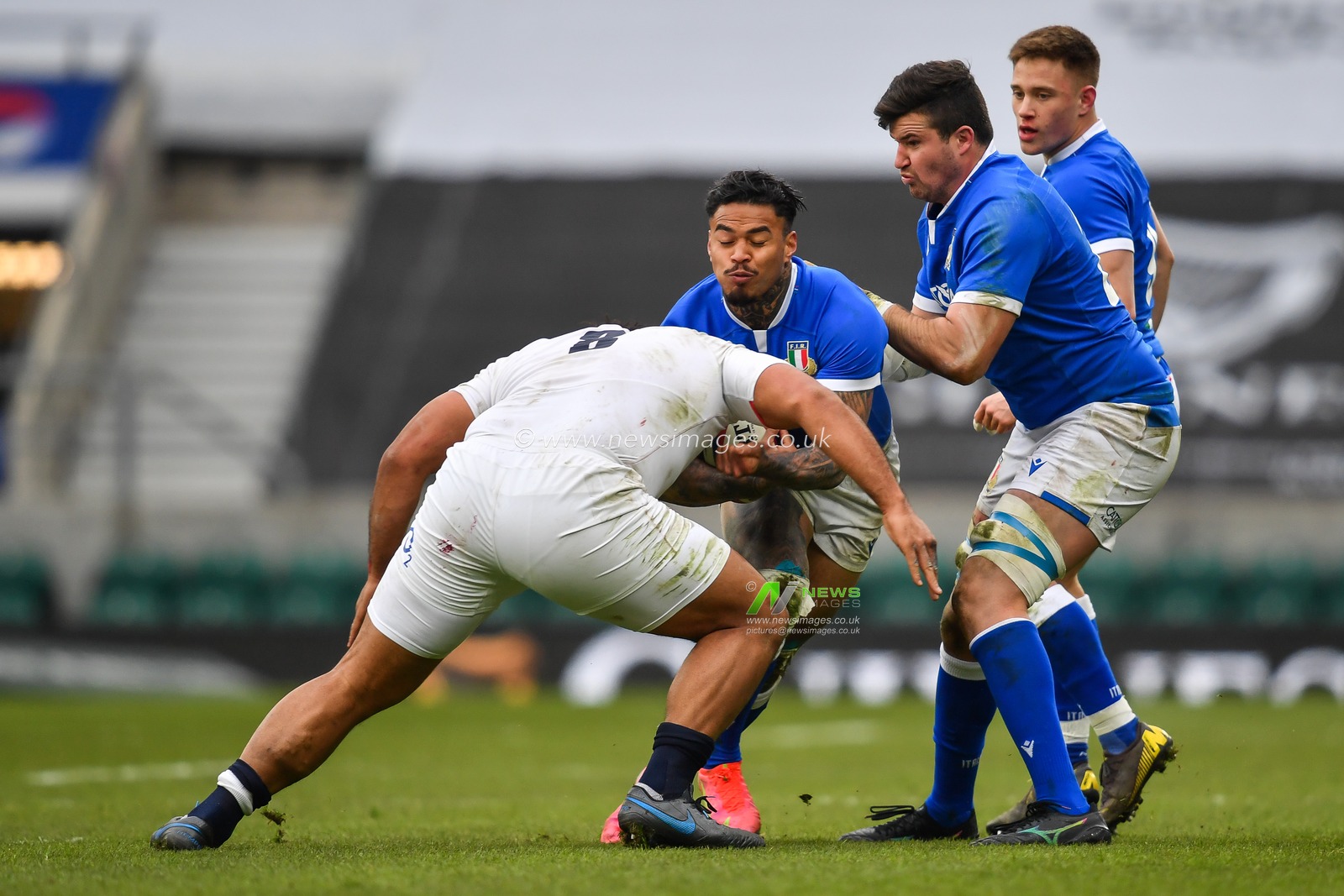 Monty Ioane of Italy is tackled by Billy Vunipola of England