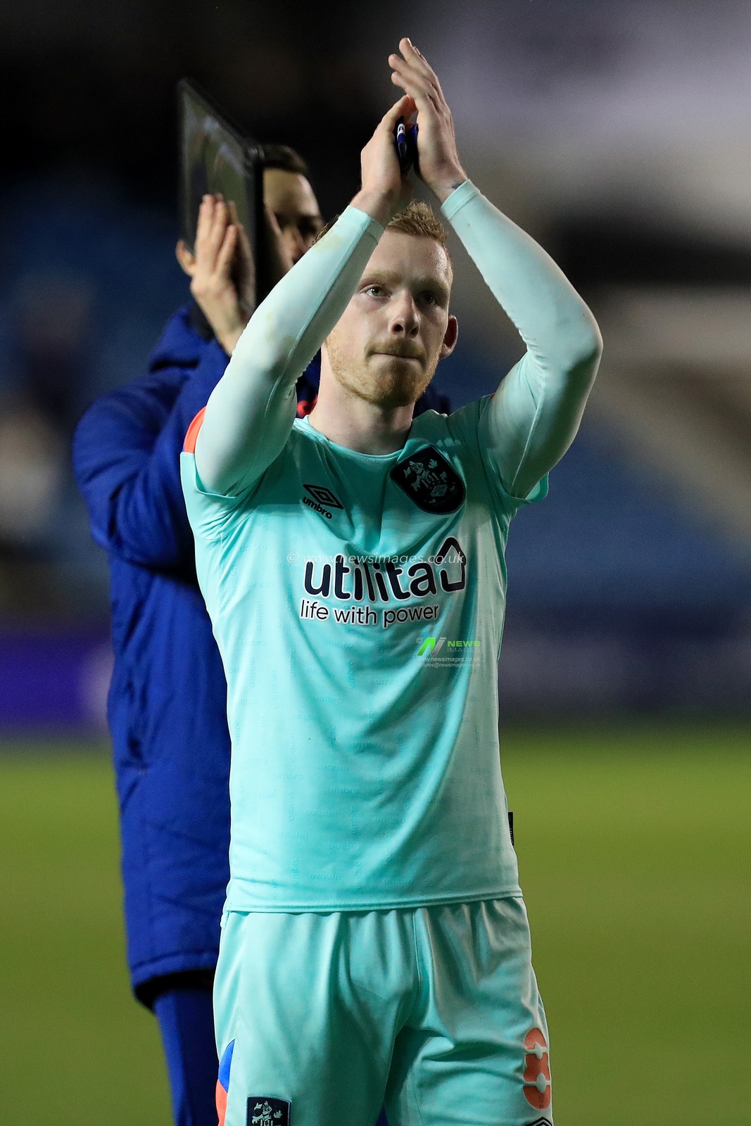 Lewis O'Brien #8 of Huddersfield Town applauds the support.