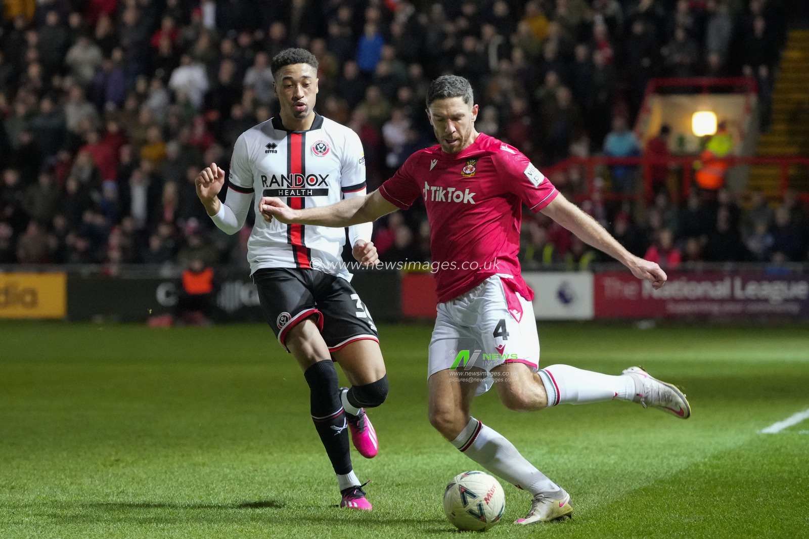 Ben Tozer #4 of Wrexham clears under pressure from Daniel Jebbison #36 of Sheffield United during the Emirates FA Cup fourth round match Wrexham vs Sheffield United at The Racecourse Ground, Wrexham, United Kingdom, 29th January 2023

(Photo by Steve Flynn/News Images)
