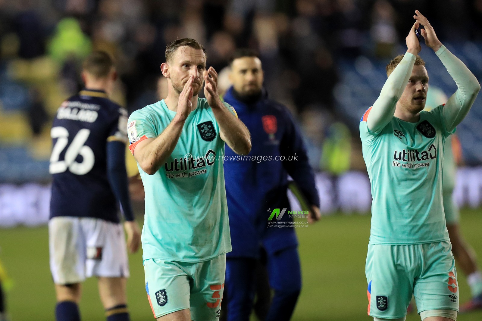 An unhappy Tom Lees #32 of Huddersfield Town claps the support.