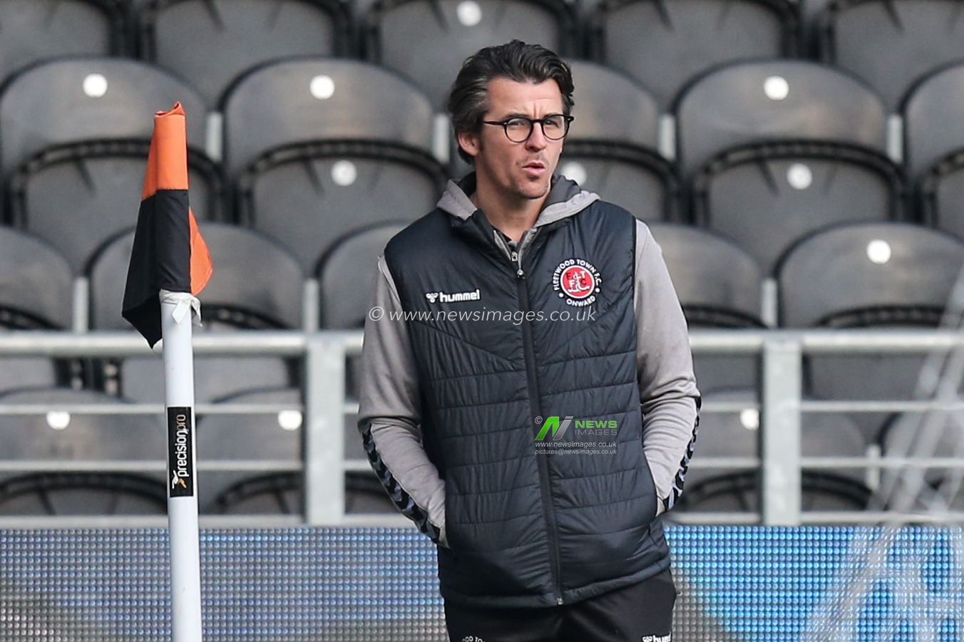 Joey Barton manager of Fleetwood Town inspects the KCOM Stadium pitch prior to kick off