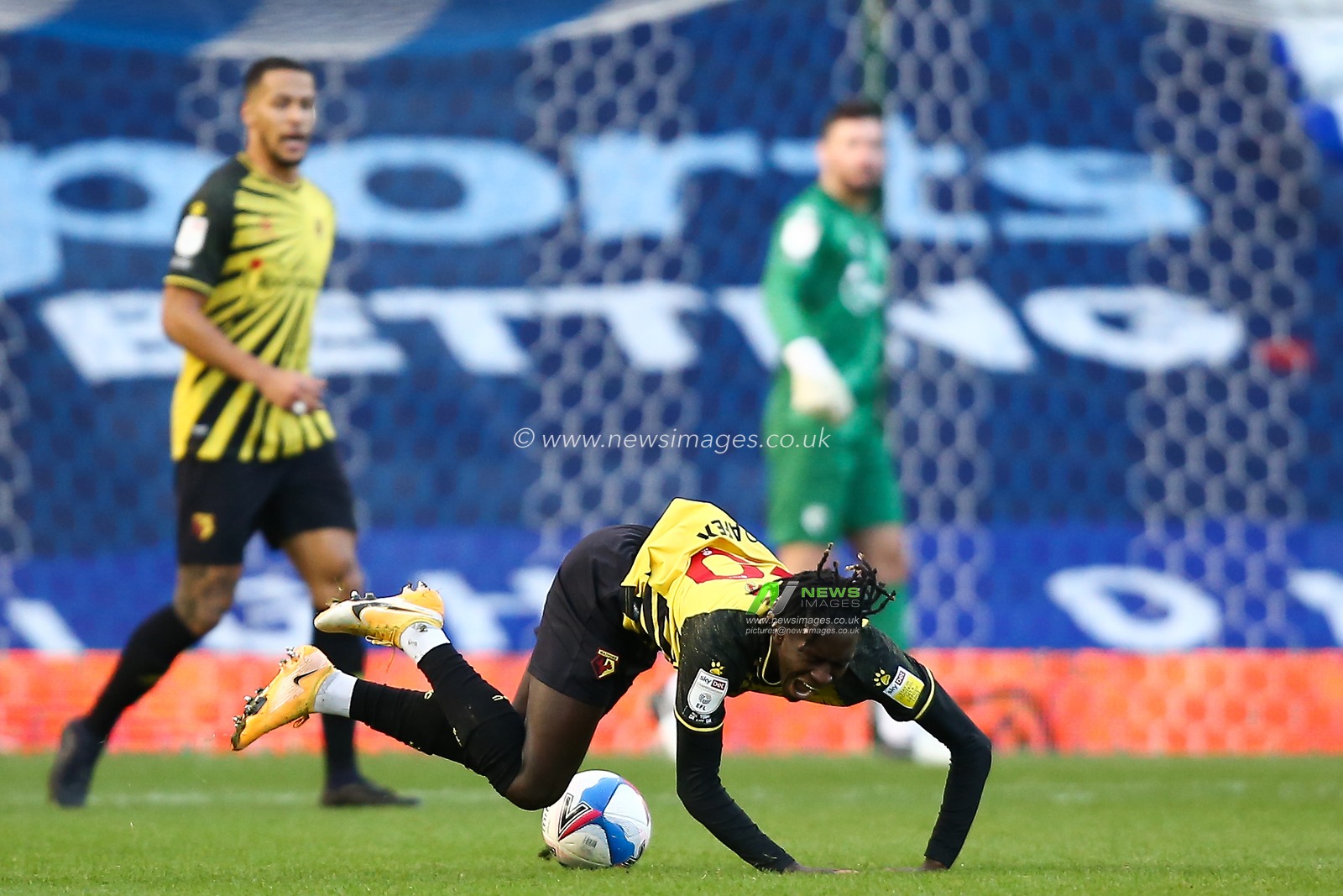 Domingos Quina #20 of Watford takes a tumble after being fouled