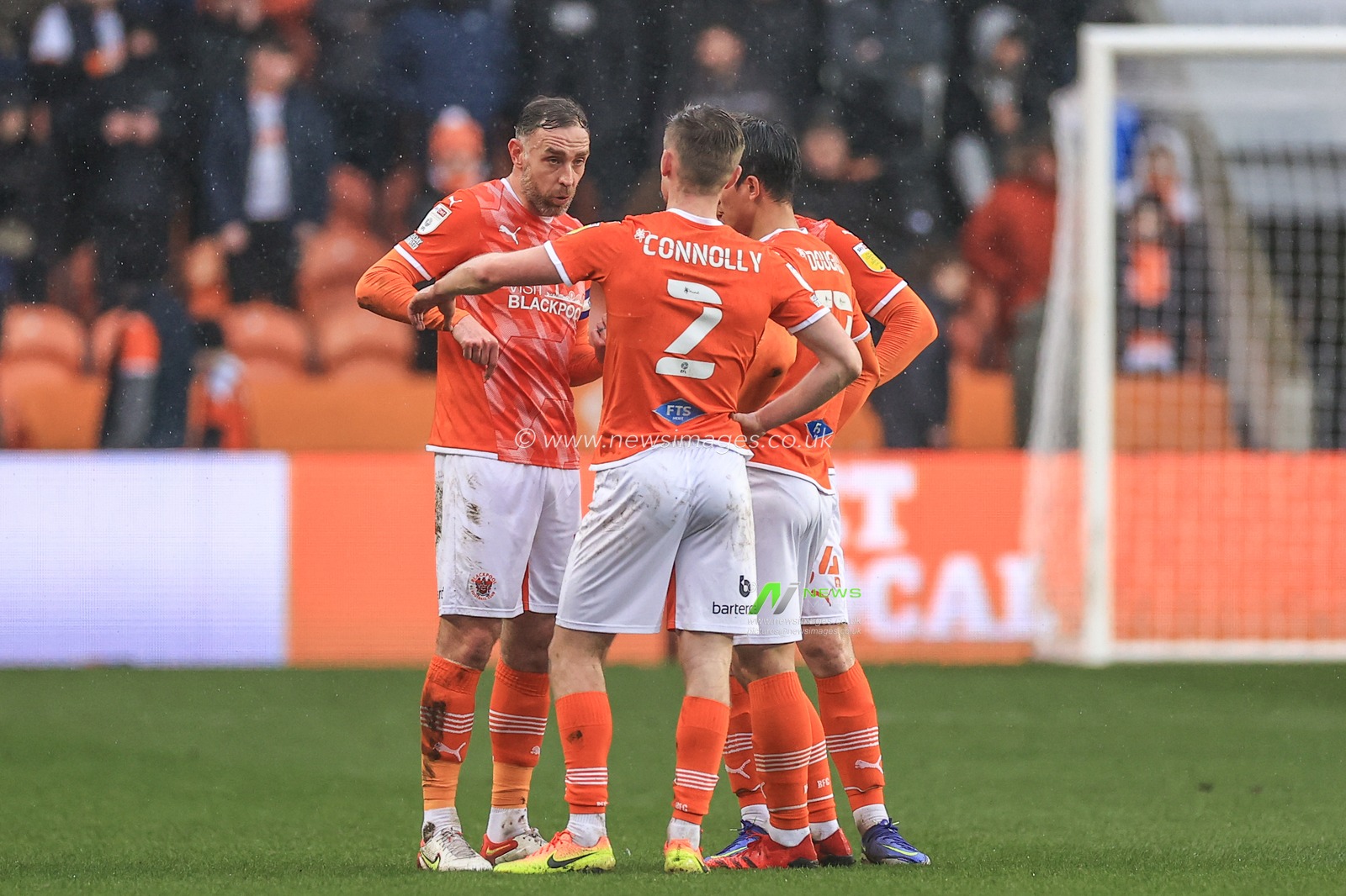 Richard Keogh #26 of Blackpool talks to Callum Connolly #2 of Blackpool,Kenny Dougall #12 of Blackpool