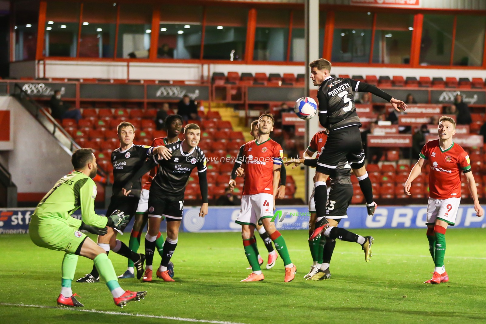 Josh Doherty (3) of Crawley Town heads the ball to safety
