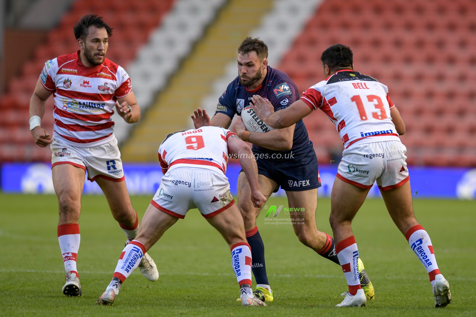Alex Walmsley (8) of St Helens is tackled by Liam Hood (9) of Leigh Centurions