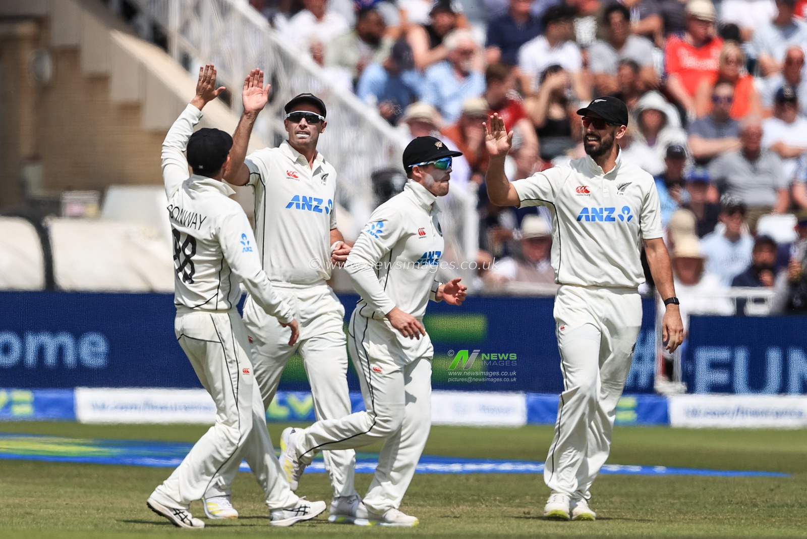 Devon Conway of New Zealand celebrates with Tim Southee of New Zealand after Zak Crawley of England goes for a duck