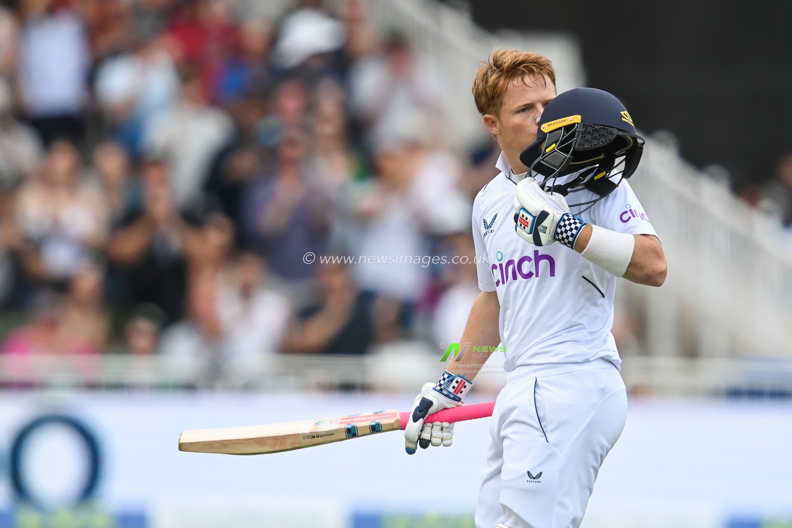 Ollie Pope of England celebrates a century (100 runs) and kisses his helmet