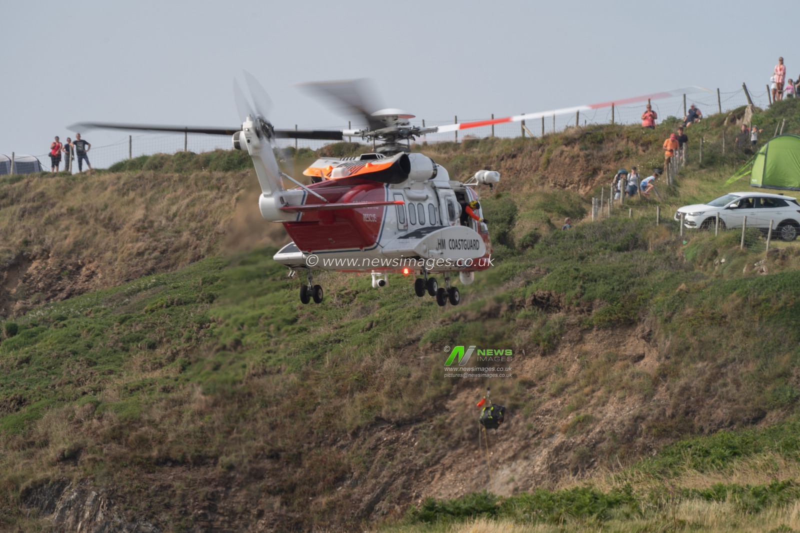 HM Coastguard helicopter is called to assist the local lifeguards and the RNLI on helping a person who had fallen on cliffs near Whitesands Beach, Pembrokeshire.