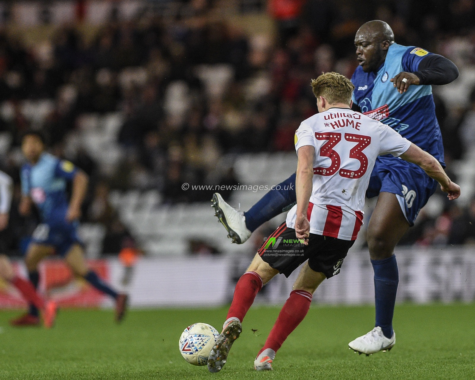 11th January 2020, Stadium Of Light, Sunderland, England; Sky Bet League 1, Sunderland v Wycombe Wanderers : Denver Hume (33) of Sunderland  under pressure from Adebayo Akinfenwa (20) of Wycombe Wanderers

Credit: Iam Burn/News Images