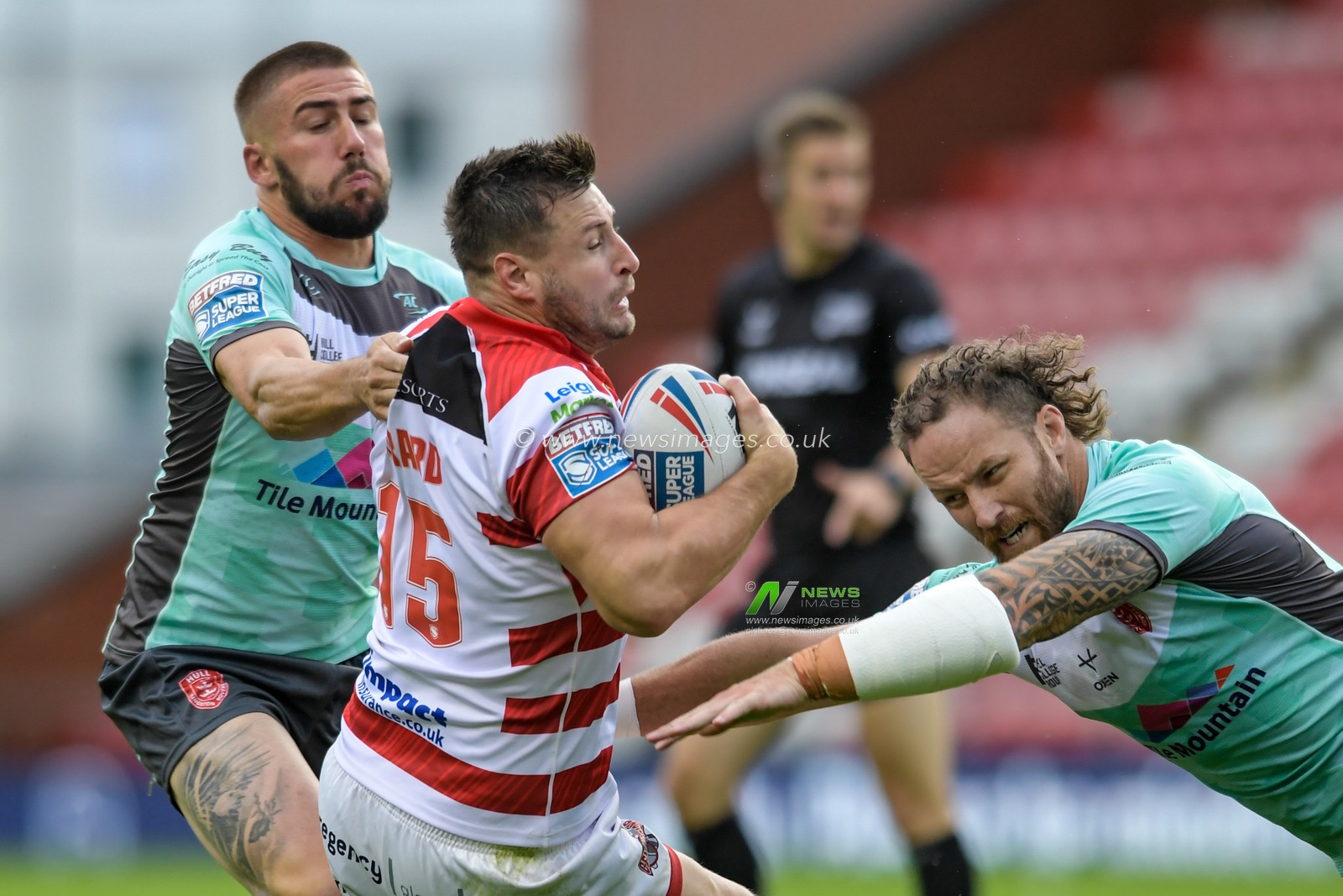 Alex Gerrard (15) of Leigh Centurions is tackled by Korbin Sims (10) of Hull KR and Greg Minikin (3) of Hull KR