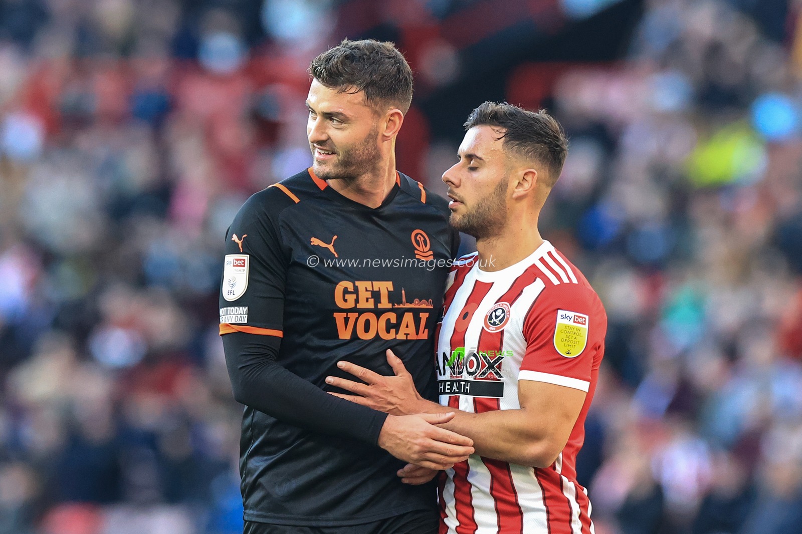 Gary Madine #14 of Blackpool and George Baldock #2 of Sheffield United with a bit of friendly banter as the await a Blackpool corner