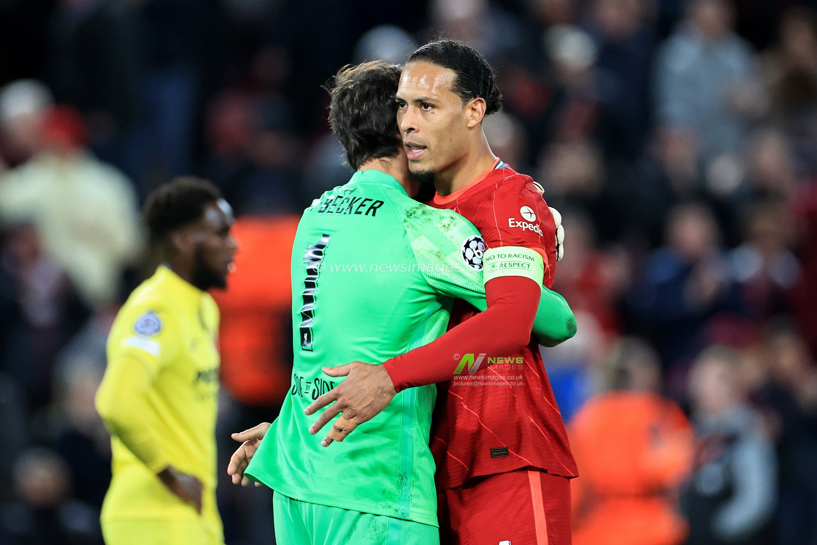 Alisson Becker #1 of Liverpool hugs Virgil van Dijk #4 of Liverpool at full time