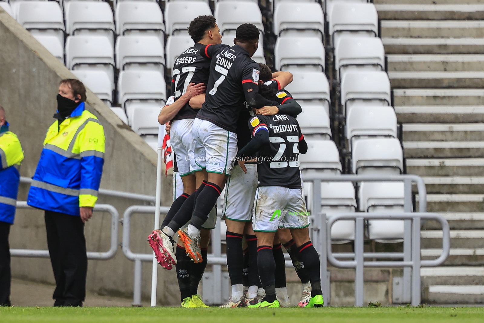 Tom Hopper #9 of Lincoln City celebrates his goal with his teammates to make it 2-1