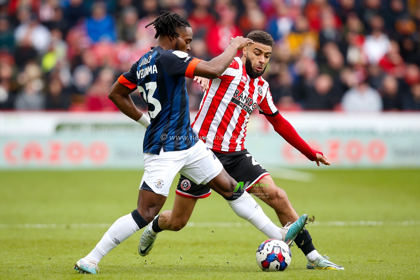 Fred Onyedinma #23 of Luton Town and Jayden Bogle #20 of Sheffield United during the Sky Bet Championship match Sheffield United vs Luton Town at Bramall Lane, Sheffield, United Kingdom, 11th March 2023

(Photo by Ben Early/News Images)